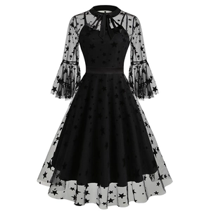 Close-up detail of gothic star mesh embroidery and flared sleeves on a black dress