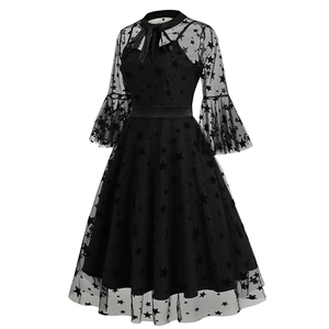 Detail of gothic black mesh dress featuring star prints, bell sleeves and bow neckline