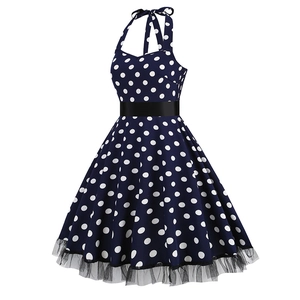 Detail of retro polka dot halter dress featuring waist belt and lace mesh hemline