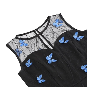 Detailed view of black lace neckline with 3D blue butterfly appliques and embroidery