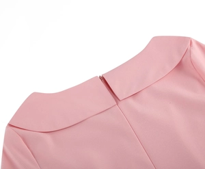 Close-up of pink button collar dress showing peter pan collar and hidden back zipper detail