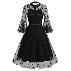 Close-up of the black sheer mesh fabric with velvet star embroidery and ruffled sleeves