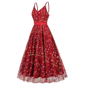 Detailed close-up of intricate multi-color floral embroidery on dark red mesh dress