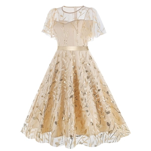 Detail of elegant champagne evening dress with gold leaf sequins and satin waist belt