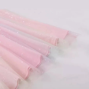 Pink halter cocktail dress featuring shimmering sequins and layered mesh details
