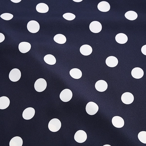 Macro view of navy blue fabric with white polka dots and fine woven textile texture
