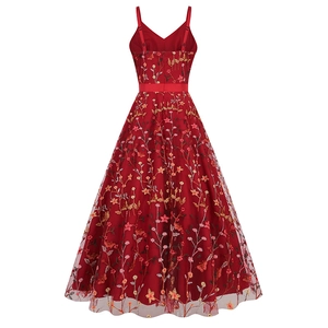 Detailed macro view of the intricate floral embroidery on deep red mesh evening dress