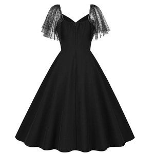 Detail of vintage black Hepburn dress featuring polka dot mesh ruffle sleeves and V-back