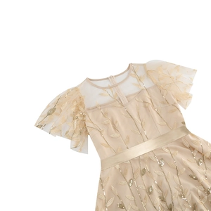 Detail of champagne gold party dress with sequin leaf embroidery and mesh sleeves