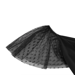 Detail of vintage mesh puff sleeve with polka dots and ruffled edges on black dress
