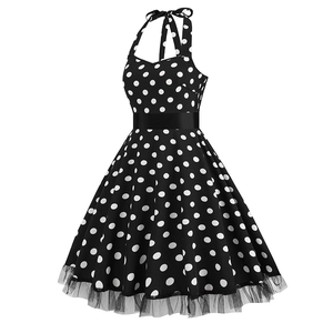 Close-up of retro polka dot dress with mesh trim hem and elegant waist detail