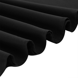 Detailed view of black mesh patchwork fabric with fine texture and smooth draping effect