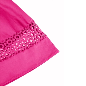 Detailed macro view of rose pink cocktail dress with hollow crochet lace stitching details