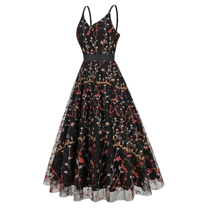 Close-up of intricate floral and butterfly embroidery on black mesh V-neck dress