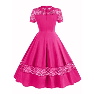 Detail of rose red 50s vintage dress showing intricate lace patchwork on the back and hem