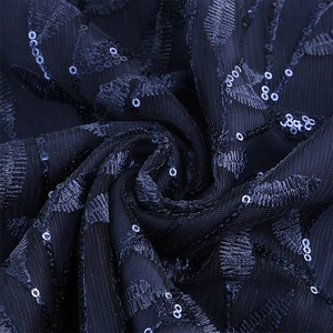 Close-up of navy blue mesh fabric with sequin embroidery and delicate leaf patterns