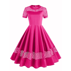 Retro 1950s pink cocktail dress with round neck, short sleeves and lace splicing detail