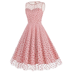 Détail de la robe rétro des années 50 rose avec encolure en tulle et motifs de cœurs rouges