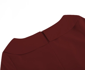 Detail view of burgundy vintage dress featuring a lapel collar and a hidden back zipper