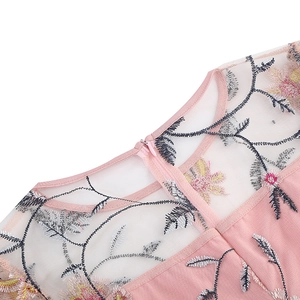 Detail of floral embroidery on pink mesh fabric with a concealed back zipper