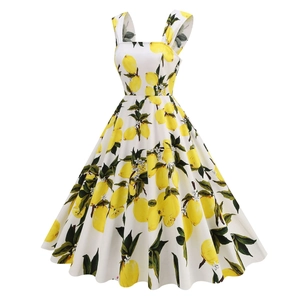 Detail of vintage square neck dress featuring fresh lemon fruit print on white fabric