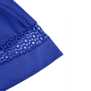 Detailed view of dark blue dress hem with intricate round hollow lace embroidery and fabric