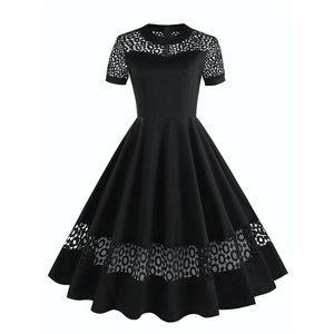 Detail view of 1950s vintage black A-line dress with circular hollow lace stitching