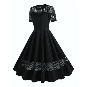 Detailed view of intricate mesh hollow lace patterns on a vintage black A-line cocktail dress