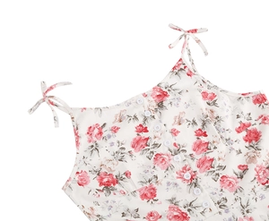 Detail view of floral vintage camisole featuring white buttons and bow shoulder straps