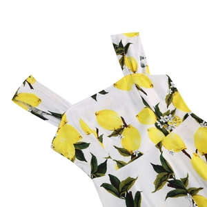 Detail of square neckline and wide straps on white summer dress with lemon prints