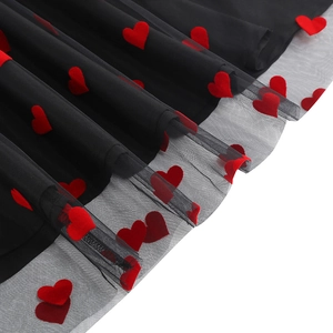 Vue détaillée de la jupe en maille noire avec broderie coeur en velours rouge