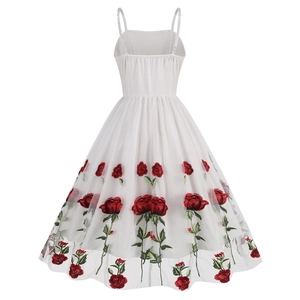 Detailed embroidery of red roses on white mesh fabric of a 1950s style vintage cocktail dress