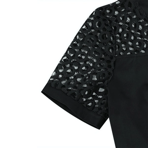 Close-up of elegant black short sleeves with intricate hollow circular lace stitching