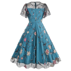 Detailed back view of peacock blue mesh dress featuring intricate floral embroidery