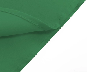 Detailed close-up of green vintage dress fabric showing fine texture and neat stitching