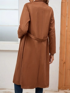 Rear view of long dark brown suede trench coat with shoulder drop and waist detail