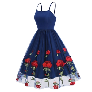 Detail of red rose embroidery on navy blue mesh skirt of retro cocktail dress
