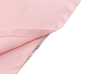Macro detail of pink mesh embroidery fabric featuring precise double-stitched hem edges