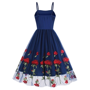 Detailed close-up of red rose embroidery on navy blue mesh strap dress skirt