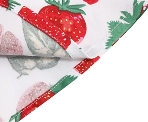 Close-up of strawberry print hem detail with professional stitching on a white dress