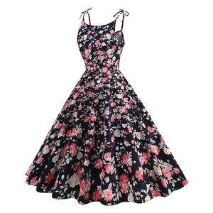 Close-up of navy floral vintage dress with white buttons and pink rose pattern detail