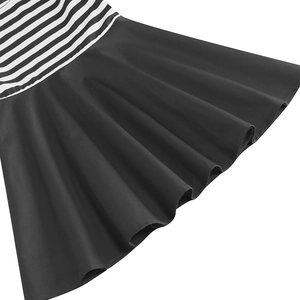 Detailed close-up showing the high-quality striped fabric and flared black skirt hem