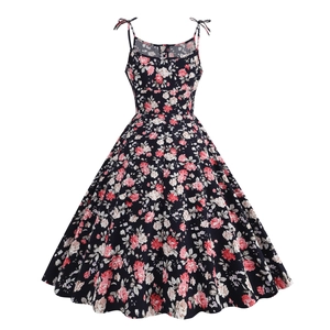 Macro shot of pink floral pattern on dark blue retro style vintage cocktail dress