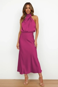 Detail of elegant magenta satin halter neck dress with draped neckline and high-waist cut
