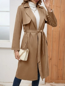 Close-up of camel faux suede coat featuring large lapels and belted waist detail