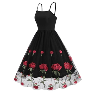 Detail of red rose embroidery on black mesh skirt of a vintage Audrey Hepburn style dress