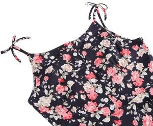 Close-up of floral 50s vintage dress with rose patterns, shoulder bows, and front buttons