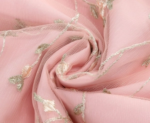 Close-up of pink mesh fabric with detailed rose embroidery and champagne gold threads