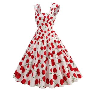 Detail view of the vintage 50s square neck dress with red cherry print on white fabric