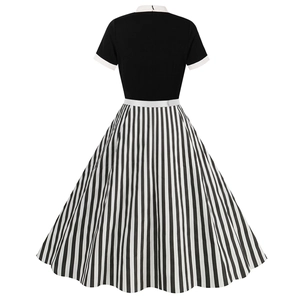 Back view of a 1950s vintage dress featuring black bodice and white striped flared skirt